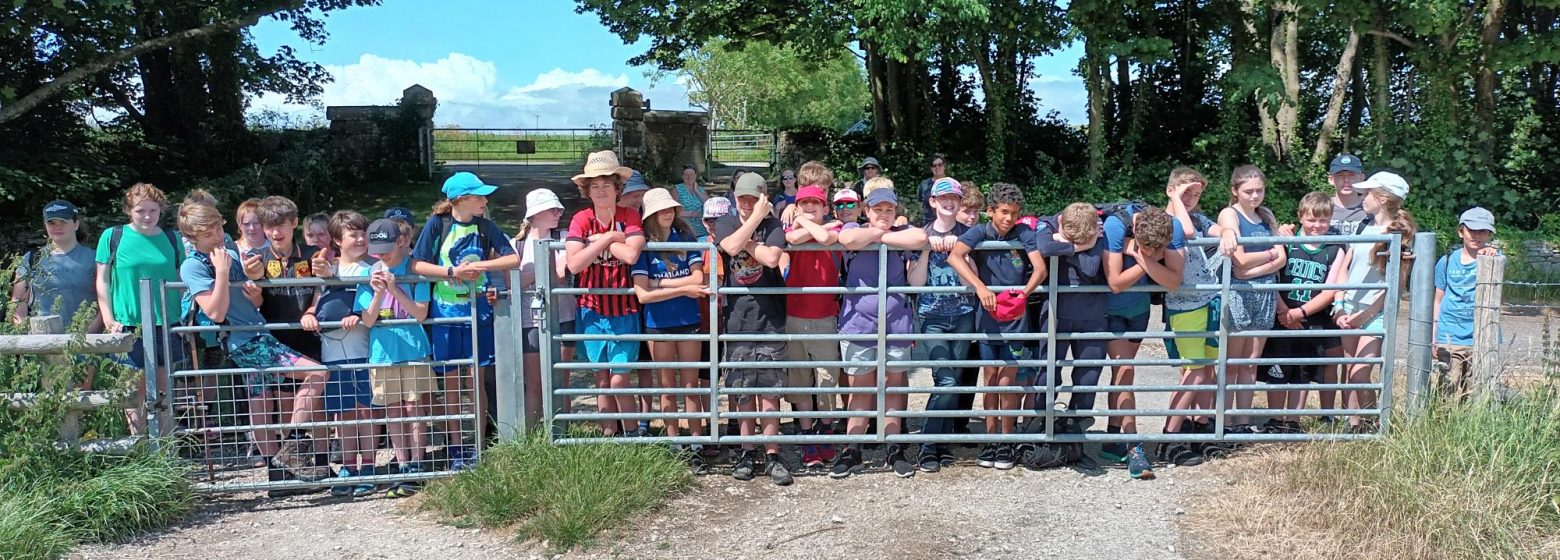 students leaning against a gate