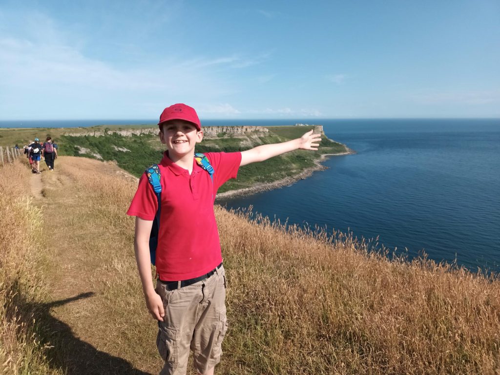 student pointing out to the coast
